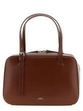 A.P.C. brown cowhide leather handbag featuring a structured minimalist silhouette and gold-tone hardware.