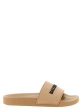 Balenciaga beige plastic slides featuring a minimalist wide strap and ergonomic footbed for refined summer comfort.
