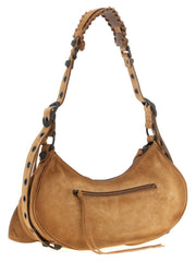 Side profile of the Balenciaga leather shoulder bag in rich brown, highlighting the slim gusset and refined stitching.