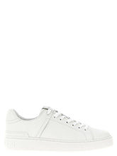 Balmain white calfskin low top sneakers for women featuring a clean minimalist silhouette and tonal lace-up front.