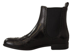 Rear view of Dolce & Gabbana ankle boots highlighting the seamless leather construction and pull-tab detail.
