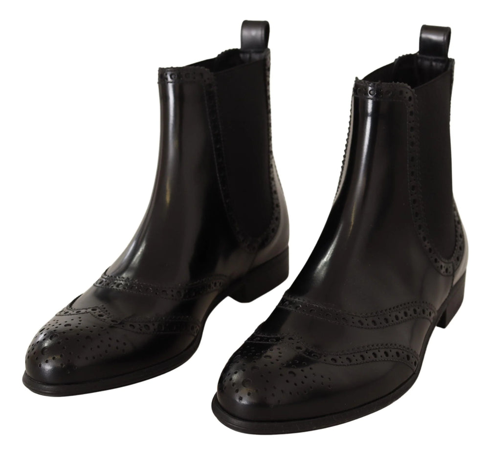 Dolce & Gabbana black leather ankle-high flat Chelsea boots featuring a sleek silhouette and elasticated side panels.