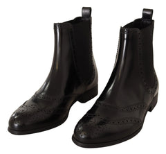 Dolce & Gabbana black leather ankle-high flat Chelsea boots featuring a sleek silhouette and elasticated side panels.