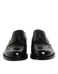 أحذية Dolce & Gabbana جلدية سوداء من جلد العجل بنهاية wingtip مع ثقوب بروج كلاسيكية ورباط أمامي.