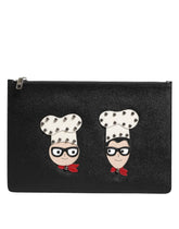 Dolce & Gabbana black leather men's clutch bag featuring colorful #DGFAMILY character embellishments and zip closure.