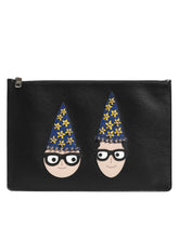 Dolce & Gabbana black leather men's clutch bag featuring colorful #DGFAMILY character embellishments and top zip closure.