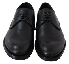 Side profile of Dolce & Gabbana black leather lace-up formal shoes showing the refined silhouette and stacked heel.
