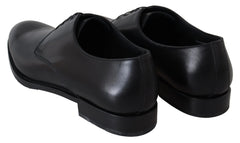 Top-down view of the polished black leather uppers and lacing system of these Dolce & Gabbana formal pumps.