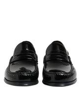 Front view of Dolce & Gabbana black leather slip-on loafers, a classic men's dress shoe with a polished finish.