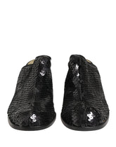 Dolce & Gabbana black sequined mules with pointed toe and elegant mid-heel, front view showcasing shimmering texture.