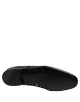 Dolce & Gabbana men's black leather slip-on loafers featuring intricate silver crystal embellishments in a front view.