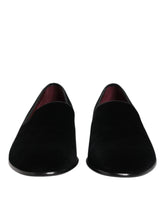 Dolce & Gabbana men's formal slip-on loafers in plush black velvet, front view showing the elegant almond toe silhouette.