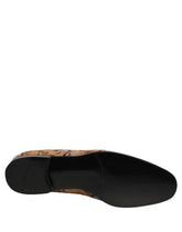 Dolce & Gabbana men's loafers in gold brocade with intricate baroque floral patterns and leather trim.