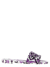 Dolce & Gabbana purple rubber slides featuring a bold embossed logo on the wide front strap, front view.