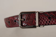 Detailní záběr na ikonické zlaté logo DG na červeném pythoním pásku, odrážející řemeslnou zručnost Dolce & Gabbana.