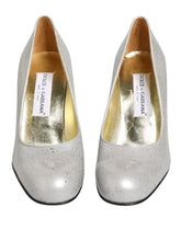 Dolce & Gabbana white leather high heel pumps featuring a classic pointed toe and elegant stiletto silhouette.