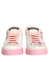 Dolce & Gabbana Portofino low top sneakers in white calf leather featuring pink Royal Pig graphics and logo details.