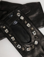 Close-up of the artisanal gold-tone floral hardware and sparkling crystals on Dolce & Gabbana black leather mittens.