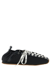 Ganni black polyamide ballet flats with pointed toe and decorative buckle straps, front view.