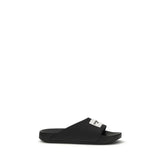 Givenchy black rubber sandals featuring a minimalist slide design with embossed logo detailing on the wide front strap.