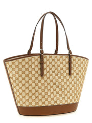 Side profile of the Gucci brown cotton handbag showing the slim silhouette and refined tonal stitching.