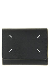 Maison Margiela black calfskin cardholder featuring the signature four white stitches on a minimalist leather exterior.