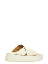 Marsell white calfskin slides featuring a minimalist wide strap and architectural flat sole for a refined summer look.