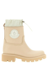 Moncler beige PVC ankle boots featuring a sleek waterproof finish and tonal chunky lug sole for refined outdoor wear.