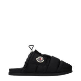 Moncler black fabric slippers featuring a quilted strap and discreet logo, presented in a refined minimalist style.