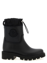 Moncler black PVC ankle boots featuring a high-gloss finish and chunky lugged rubber sole for a refined utilitarian look.