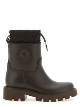 Moncler brown PVC ankle boots featuring a glossy finish and chunky lug sole for a refined weather-ready silhouette.