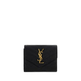 Saint Laurent black calf leather Bos Taurus wallet featuring a minimalist front profile and subtle luxury branding.
