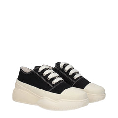 Profil latéral des baskets noires Stella McCartney présentant la semelle intermédiaire architecturale surdimensionnée et la tige textile.