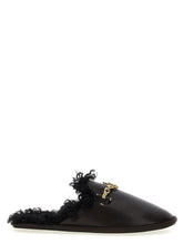 Front view of Stella McCartney brown polyethylene mules featuring a minimalist slip-on design and rounded toe.