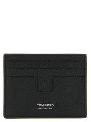 Εμπρόσθια άποψη του πορτοφολιού καρτών Tom Ford σε μαύρο δέρμα μοσχαριού με χρυσό λογότυπο και πολλές υποδοχές καρτών.