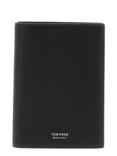 Front view of a Tom Ford black calfskin leather wallet featuring a minimalist design and subtle gold-tone logo branding.