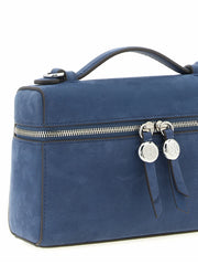 Bagfra af Tory Burch blå lammeskindtaske, der fremhæver den glatte læderfinish og rene arkitektoniske linjer.