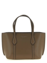 Front view of a Tory Burch brown cowhide tote bag featuring structured leather handles and a minimalist silhouette.