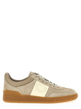Valentino Garavani beige calfskin low top sneakers featuring a minimalist profile and tonal laces for a refined aesthetic.