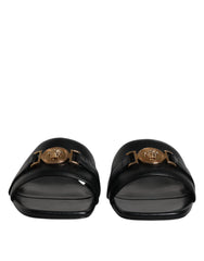 Sandales plates Versace en cuir noir avec plaque logo