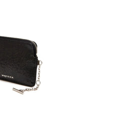 Close-up detail of the Alexander McQueen clutch bag showcasing the silver-tone hardware and precise tonal stitching.