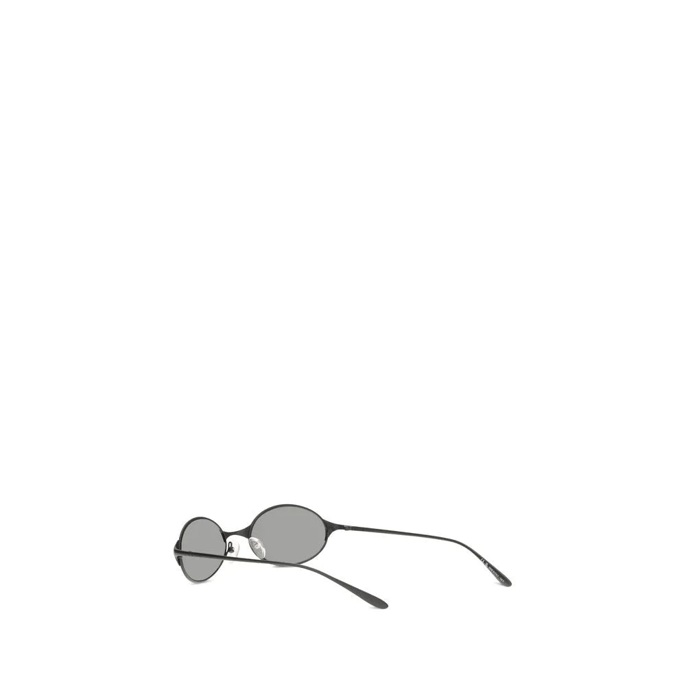 Angled view of Alexander McQueen luxury eyewear in gray metal, highlighting the refined bridge and tinted lenses.