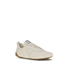 Side profile of Chloé luxury sneakers in neutral beige tones with layered technical fabric and suede panels.