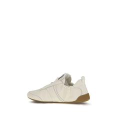 Rear view of Chloé athletic shoes highlighting the branded heel loop and textured architectural midsole design.