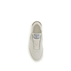 Close-up of Chloé beige sneakers showing the intricate stitching, woven laces, and premium mixed-material construction.