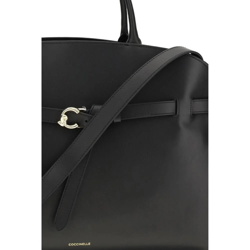 Close-up of the Coccinelle Bos Taurus handbag showing the premium pebbled leather texture and metallic logo branding.