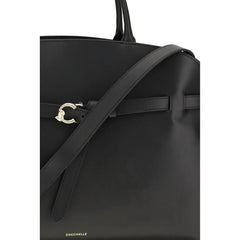 Close-up of the Coccinelle Bos Taurus handbag showing the premium pebbled leather texture and metallic logo branding.