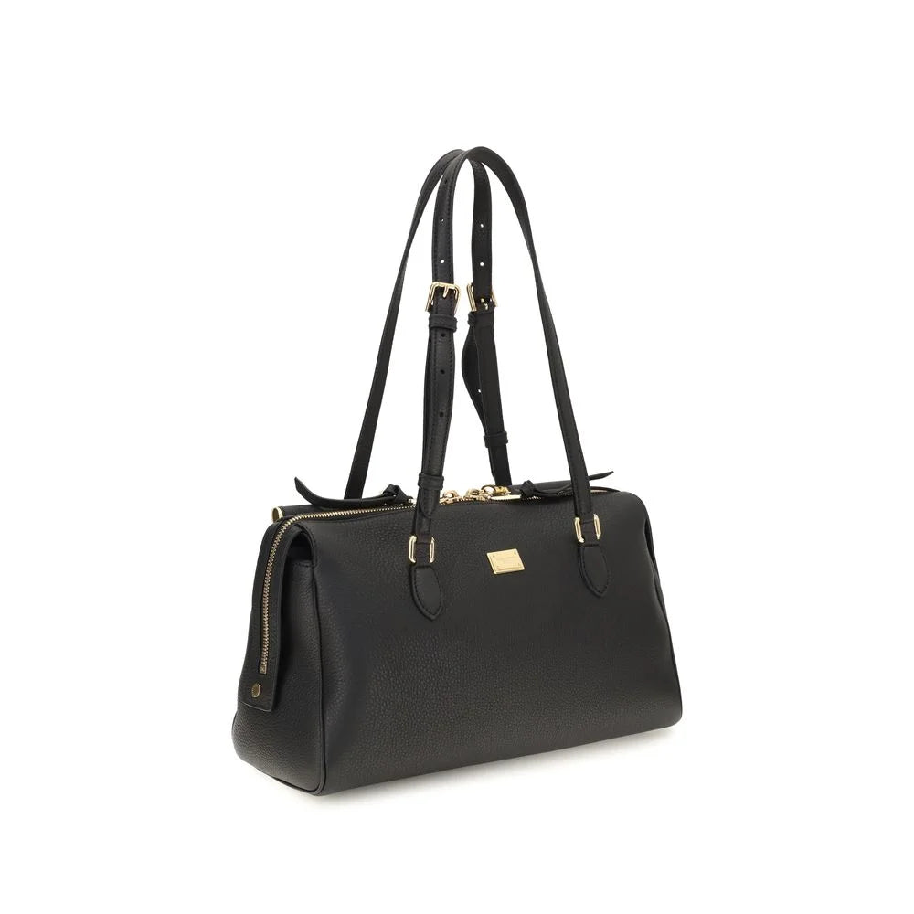 Side profile of the Dolce & Gabbana Bos Taurus bag in smooth black leather showing the slim, elegant proportions.