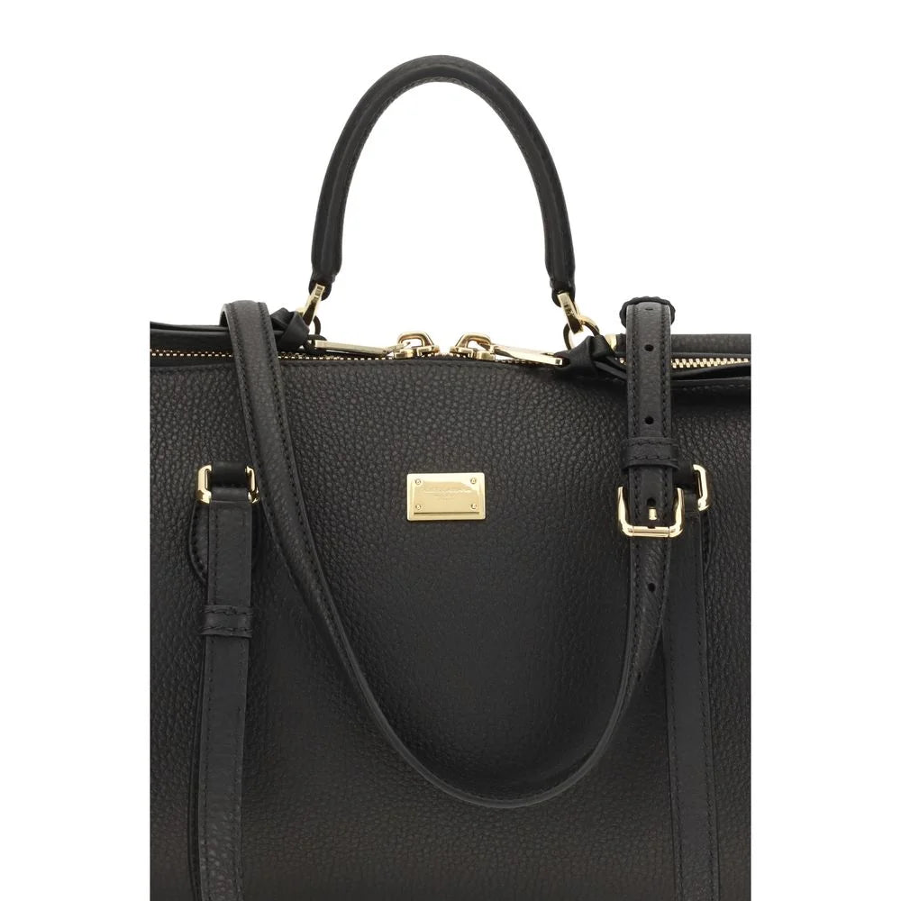 Close-up of the Dolce & Gabbana Bos Taurus bag detailing the fine grain of the black calf leather and tonal stitching.