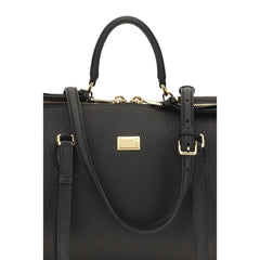 Close-up of the Dolce & Gabbana Bos Taurus bag detailing the fine grain of the black calf leather and tonal stitching.